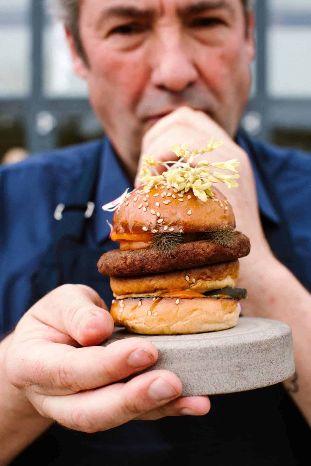 Chef Hans van Wolden with a cultivated burger